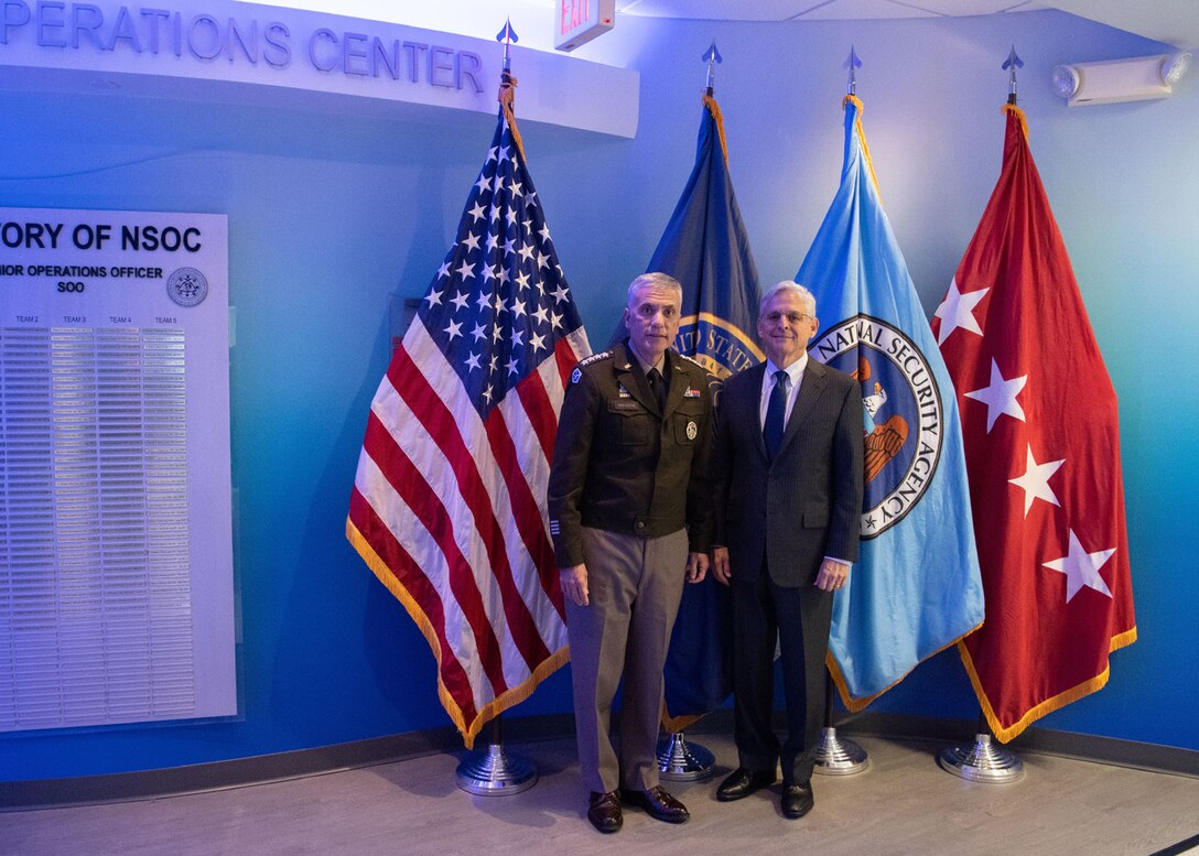 General Nakasone stands with Attorney General Merrick Garland.