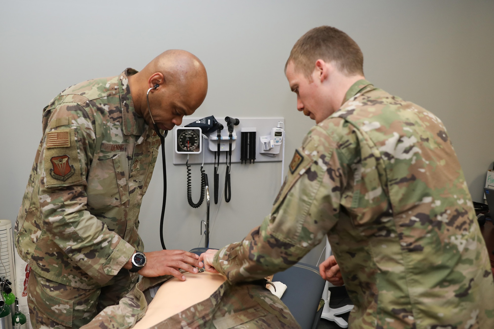 Maj. Daniel Shields (right), 445th Aeromedical Staging Squadron flight surgeon, demonstrates the heartbeat functionality of a medical mannequin to Chief Master Sergeant Travon W. Dennis (left), Fourth Air Force Command Chief, March Air Reserve Base, California, during his visit at Wright-Patterson Air Force Base, Ohio, Jan. 6, 2024. Chief Dennis visited the 445th Airlift Wing Jan. 6-7, 2024 and met with Airmen from various squadrons and the 445th Development and Training Flight, he toured the 445th Aeromedical Staging Squadron simulation lab, participated in an aircrew flight equipment demonstration and was briefed on the security forces weapons simulator training. Chief Dennis also met with the 445th's Chief’s Group, Rising Six and First Sergeant Council. (U.S. Air Force photo/Senior Airman Angela Jackson)