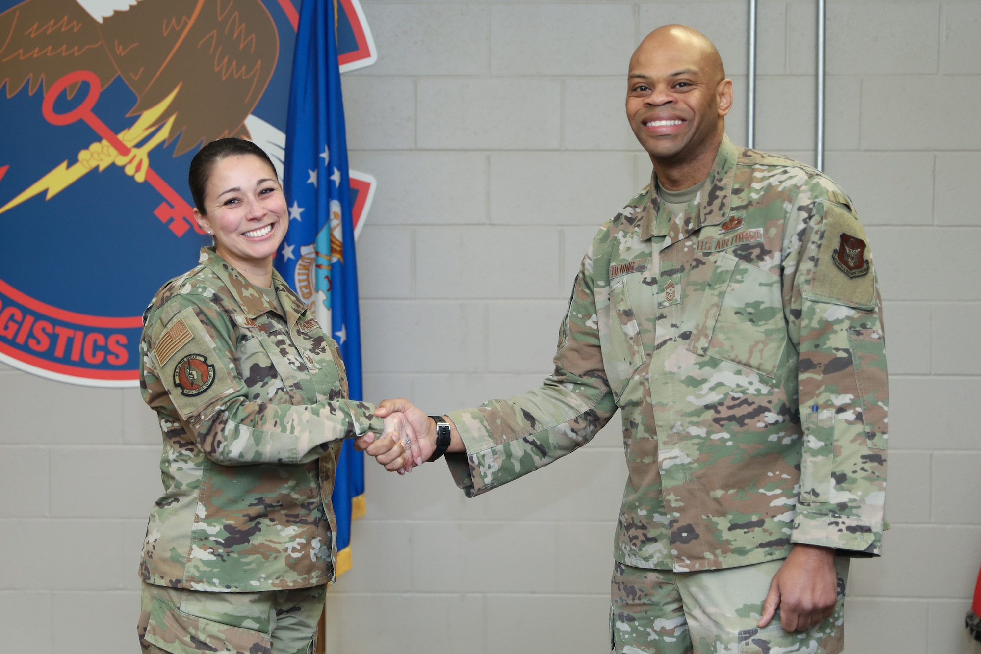 Chief Master Sgt. Travon W. Dennis, Fourth Air Force Command Chief, coins Master Sgt. Felicia Johnson, 445th Force Support Squadron NCO in charge of installation personnel readiness, for being her squadron's outstanding performer during his visit at Wright-Patterson Air Force Base, Ohio, Jan. 7, 2024. During his 2-day visit to the wing, Chief Dennis also coined the following outstanding performers; Master Sgt. Christopher Wise, 445th Operations Support Squadron; Tech. Sgt. Elizabeth Snavely, 445th Aerospace Medicine Squadron; Senior Airman Valerie Phan, 445th Aeromedical Staging Squadron; and Senior Airman Stephanie Gillispie, 445th Maintenance Squadron. (U.S. Air Force photo/Senior Airman Angela Jackson)