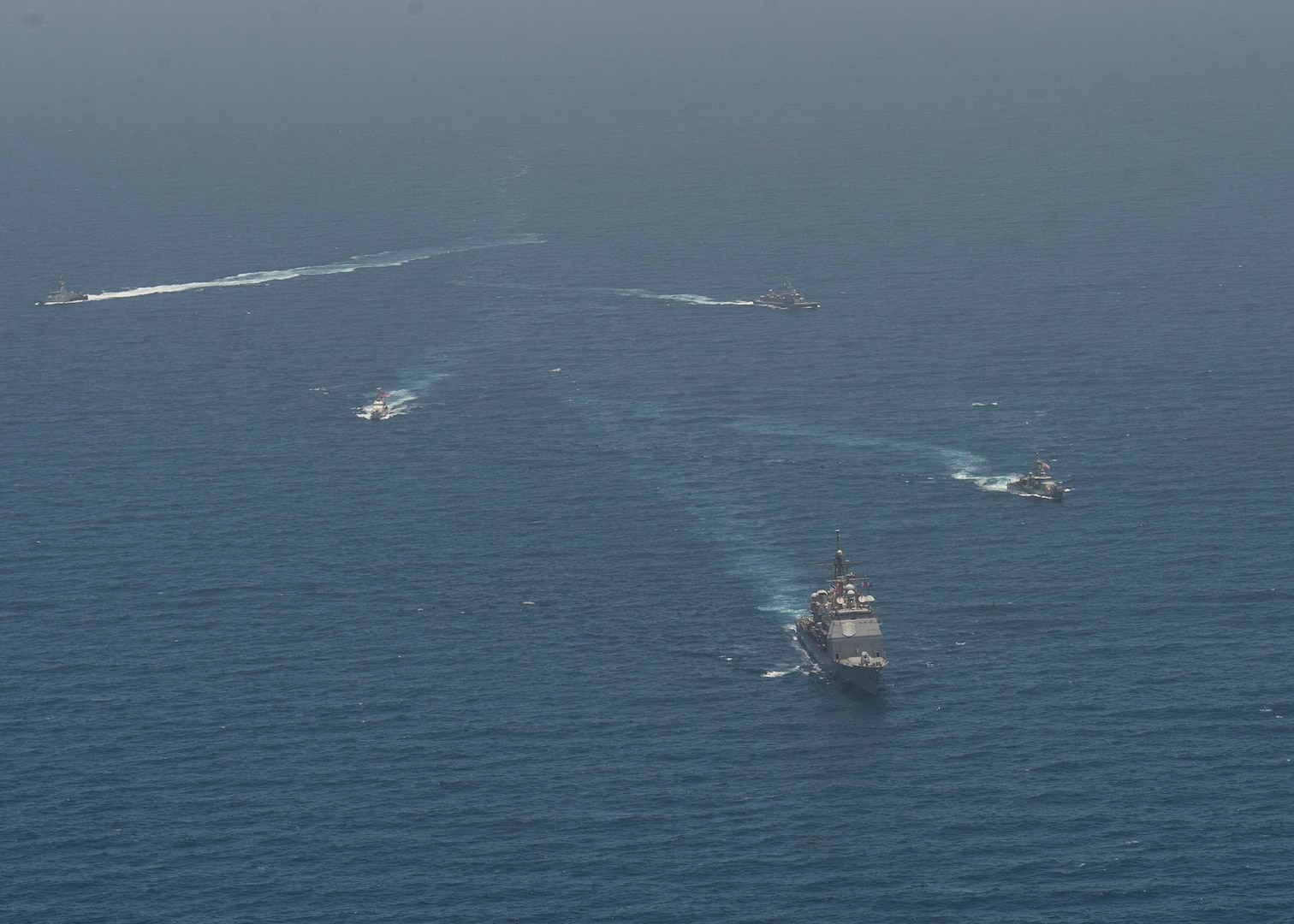 ARABIAN GULF (June 8, 2021) Guided-missile cruiser USS Vella Gulf (CG 72), patrol coastal ship USS Thunderbolt (PC 12), Coast Guard patrol boat USCGC Monomoy (WPB 1326), and Kuwait Navy patrol boats KNS Istiqlal (P5702) and KNS Al-Garoh (P3725), operate in formation during Eager Defender 21 in the Arabian Gulf, June 8. Eager Defender 21 is the capstone in a series of bilateral exercises between Kuwait and U.S. naval forces, focused on enhancing mutual capabilities and interoperability in maritime security operations. (U.S. Navy photo by Mass Communication Specialist 2nd Class Dean M. Cates)