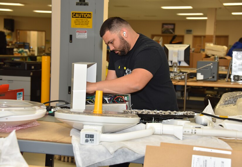 A biomedical equipment technician works on a medical device at the U.S. Army Medical Materiel Agency’s Medical Maintenance Operations Division at Hill Air Force Base, Utah. (C.J. Lovelace)