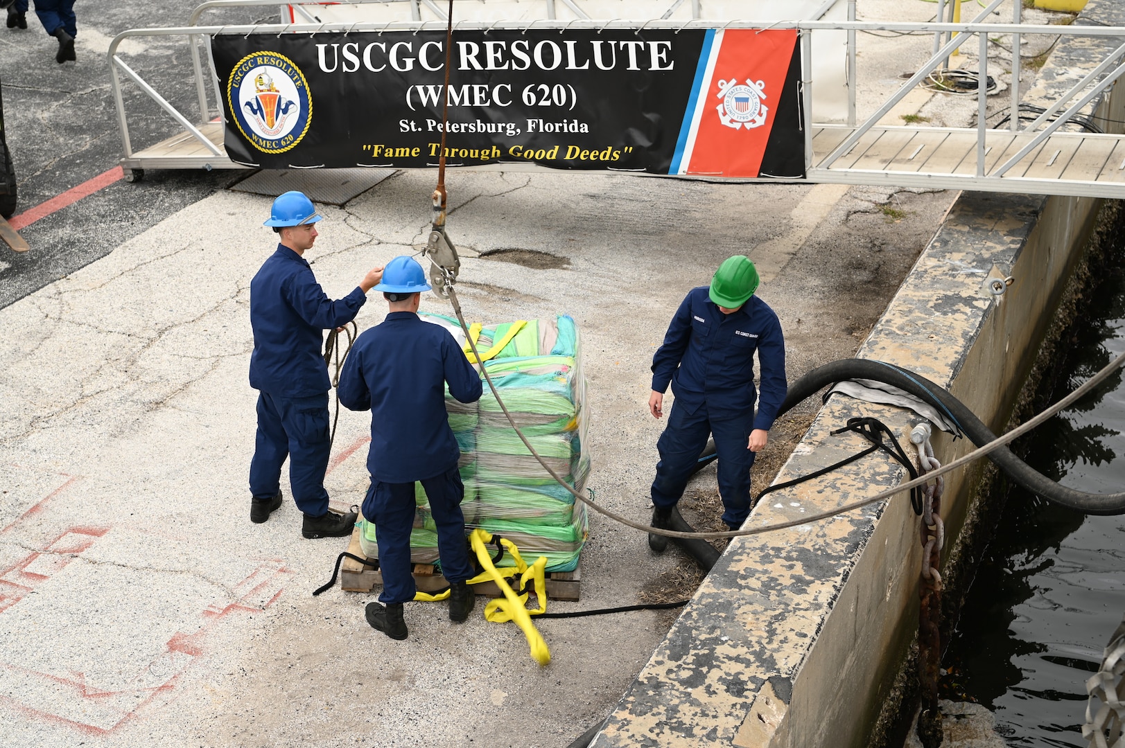 Crew of the Coast Guard Cutter Resolute unload interdicted narcotics on the pier, Jan. 29, 2024, St. Petersburg, FL. The drugs were forklifted onto trucks for destruction. (U.S. Coast Guard photo by Petty Officer 3rd Class Nicholas Strasburg)