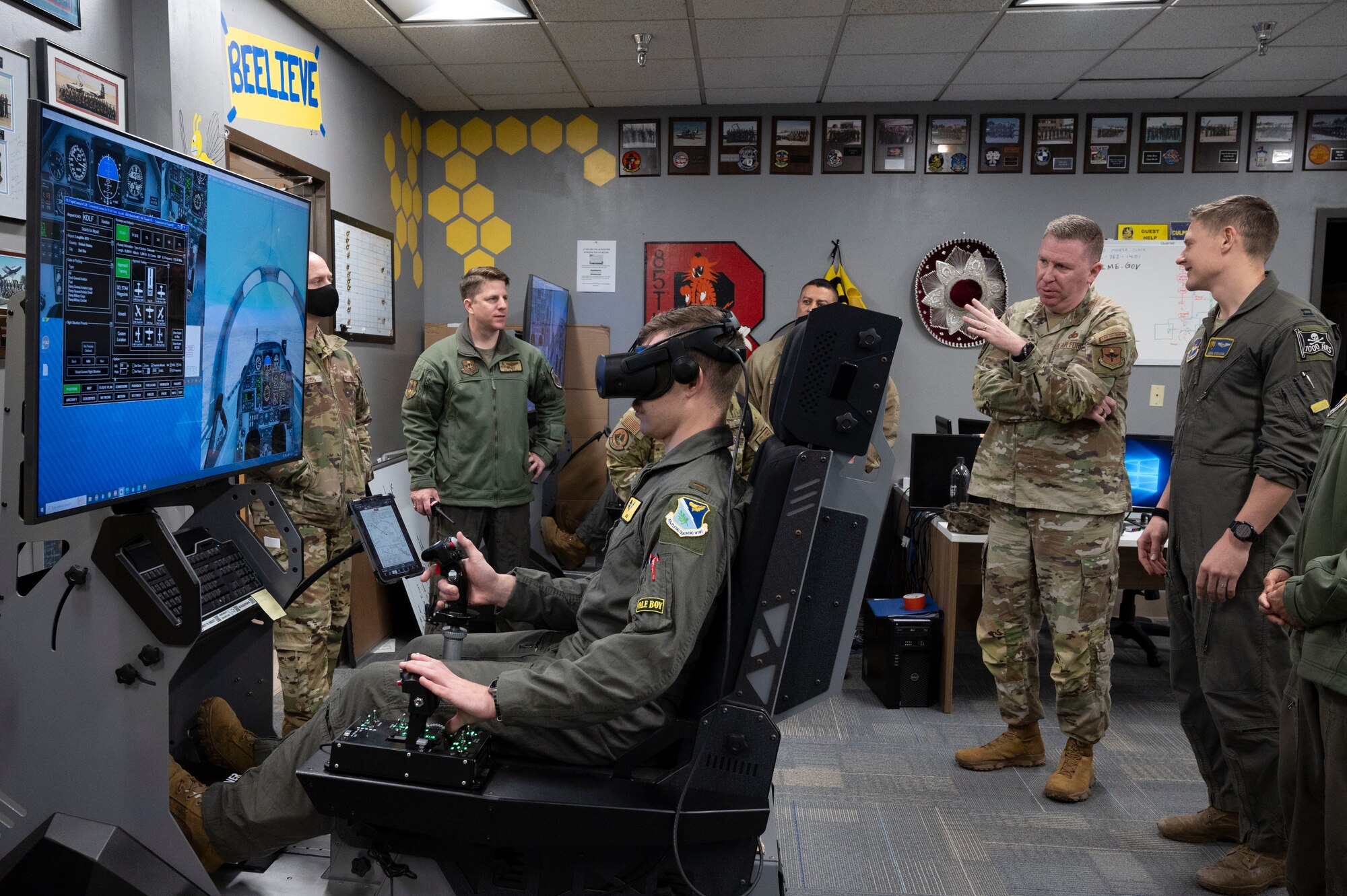 U.S. Air Force Capt. Aaron Robinson (right), 85th Flying Training Squadron T-6A Texan II instructor pilot, shows Chief Master Sgt. Chad Bickley (second from right), command chief for Air Education and Training Command, a T-6 aircraft simulator inside a 47th Student Squadron classroom at Laughlin Air Force Base, Texas, Jan. 22, 2024. Bickley spent time with Team XL members to get a closer look at of how Laughlin’s Airmen train student pilots to be the Air Force’s newest and most lethal pilots. (U.S. Air Force photo by Senior Airman Kailee Reynolds)