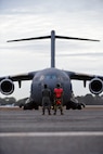 A photo of Airmen preparing to marshal a jet.