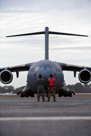 A photo of Airmen preparing to marshal a jet.