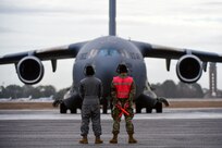 A photo of Airmen preparing to marshal a jet.