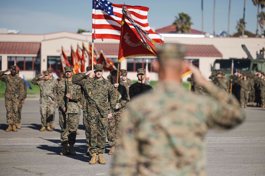 U.S. Navy Sailors and U.S. Marines, with I Marine Expeditionary Force, salute during the national anthem at a change of charge ceremony at Marine Corps Base Camp Pendleton, California, Jan. 26, 2024. The change of charge ceremony represents the relinquishment of duties from one command master chief to another. (U.S. Marine Corps photo by Sgt. Samuel C. Fletcher)