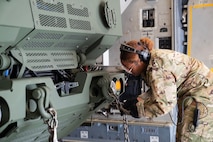 A photo of an Airman securing cargo.