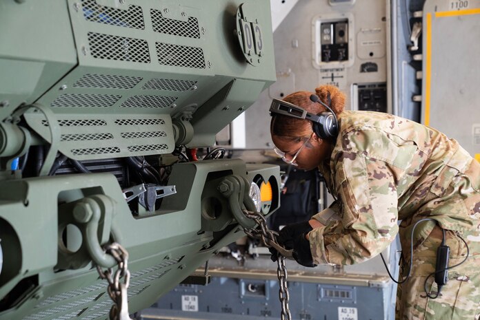 A photo of an Airman securing cargo.