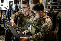A photo of Marines reviewing video.