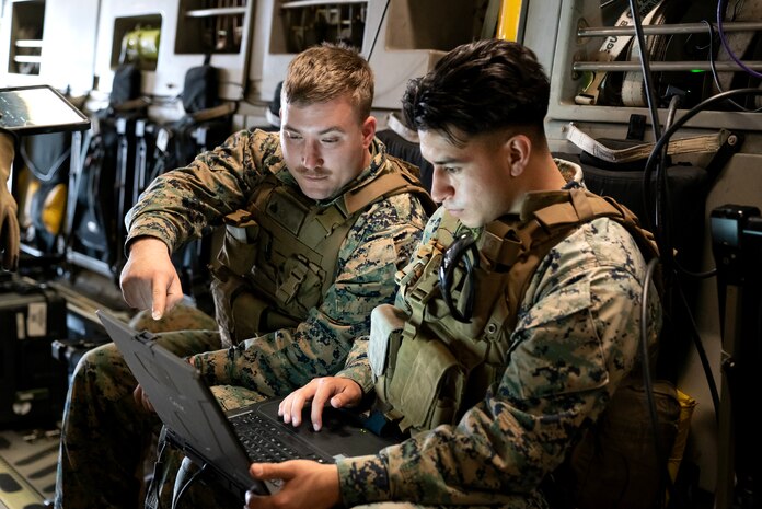 A photo of Marines reviewing video.