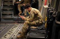 A photo of an Airman performing preflight checks.