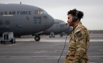 A photo of an Airman performing preflight checks.