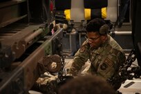 A photo of an Airman securing cargo.