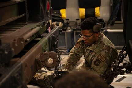A photo of an Airman securing cargo.