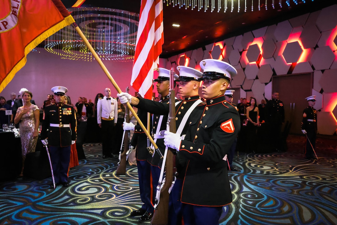 U.S. Marines assigned to the Marine Corps Base Camp Blaz color guard present arms as the National Anthem is played during the 248th Marine Corps birthday ball held in Tumon, Guam, Nov. 10, 2023. The Marine Corps birthday ceremony honors the history, legacy and traditions passed down from generation to generation since the founding of the Corps on Nov. 10, 1775. (U.S. Marine Corps photo by Gunnery Sgt. Rubin J. Tan)