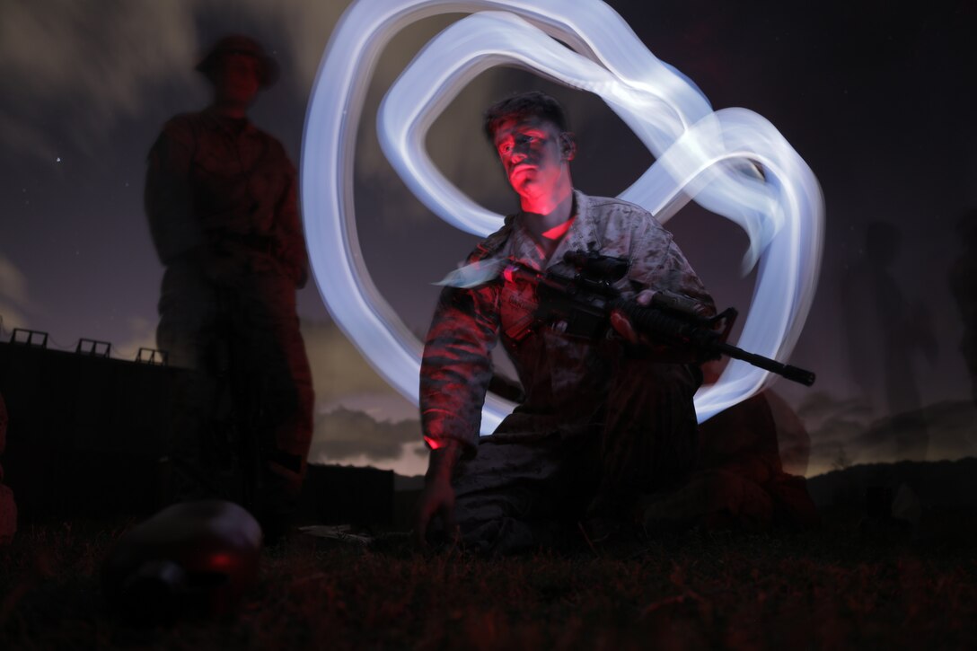 U.S. Marine Corps Cpl Joseph Gardner, distribution specialist, Headquarters Battalion, Marine Corps Base Hawaii, poses for a picture during a HQBN field exercise, MCBH, Jan. 9, 2024. The FEX was a week-long event conducted in order to increase combat readiness, unit morale and camaraderie. (U.S. Marine Corps photo by Lance Cpl. Samuel Estridge)