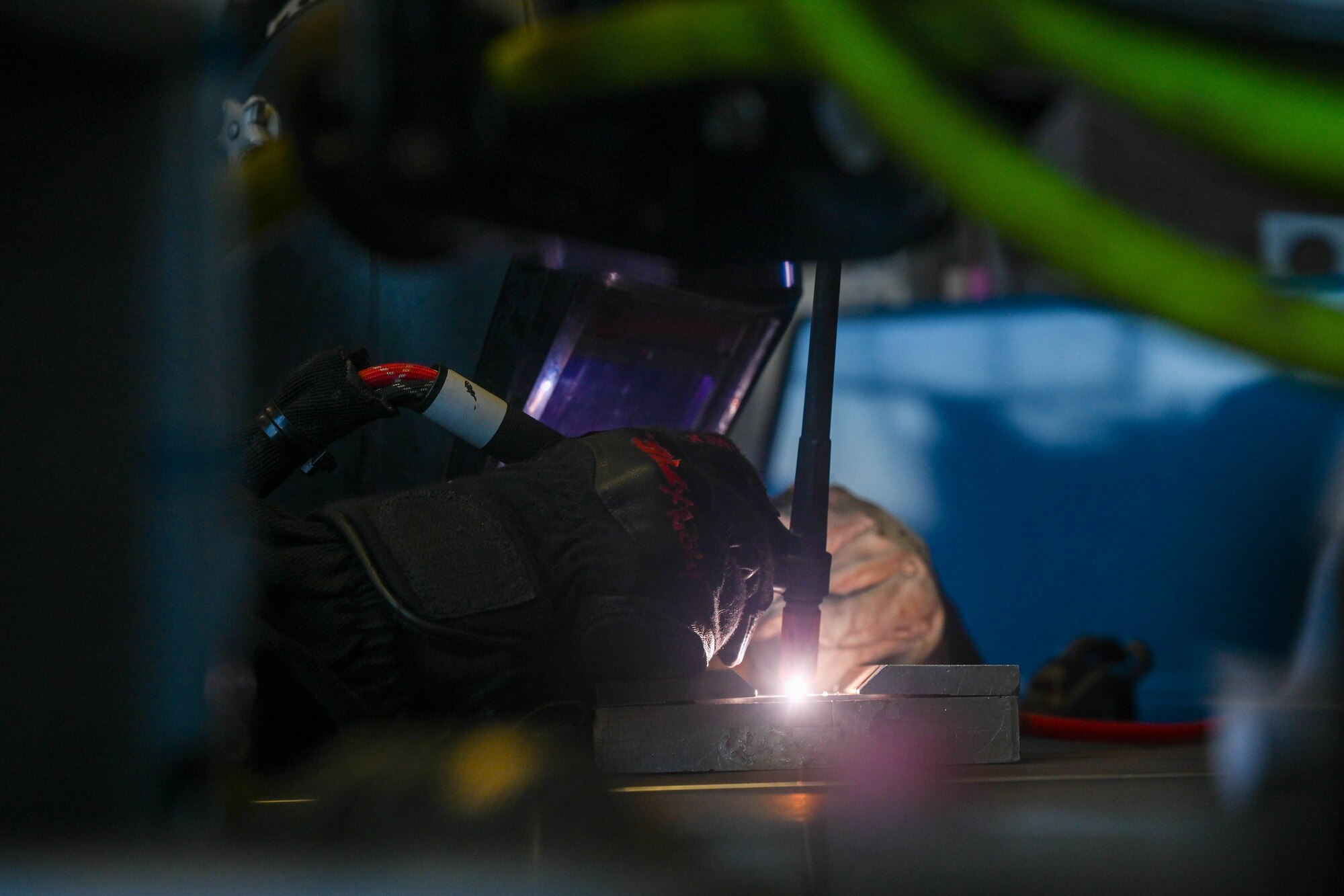 Airman uses metal fabrication equipment.