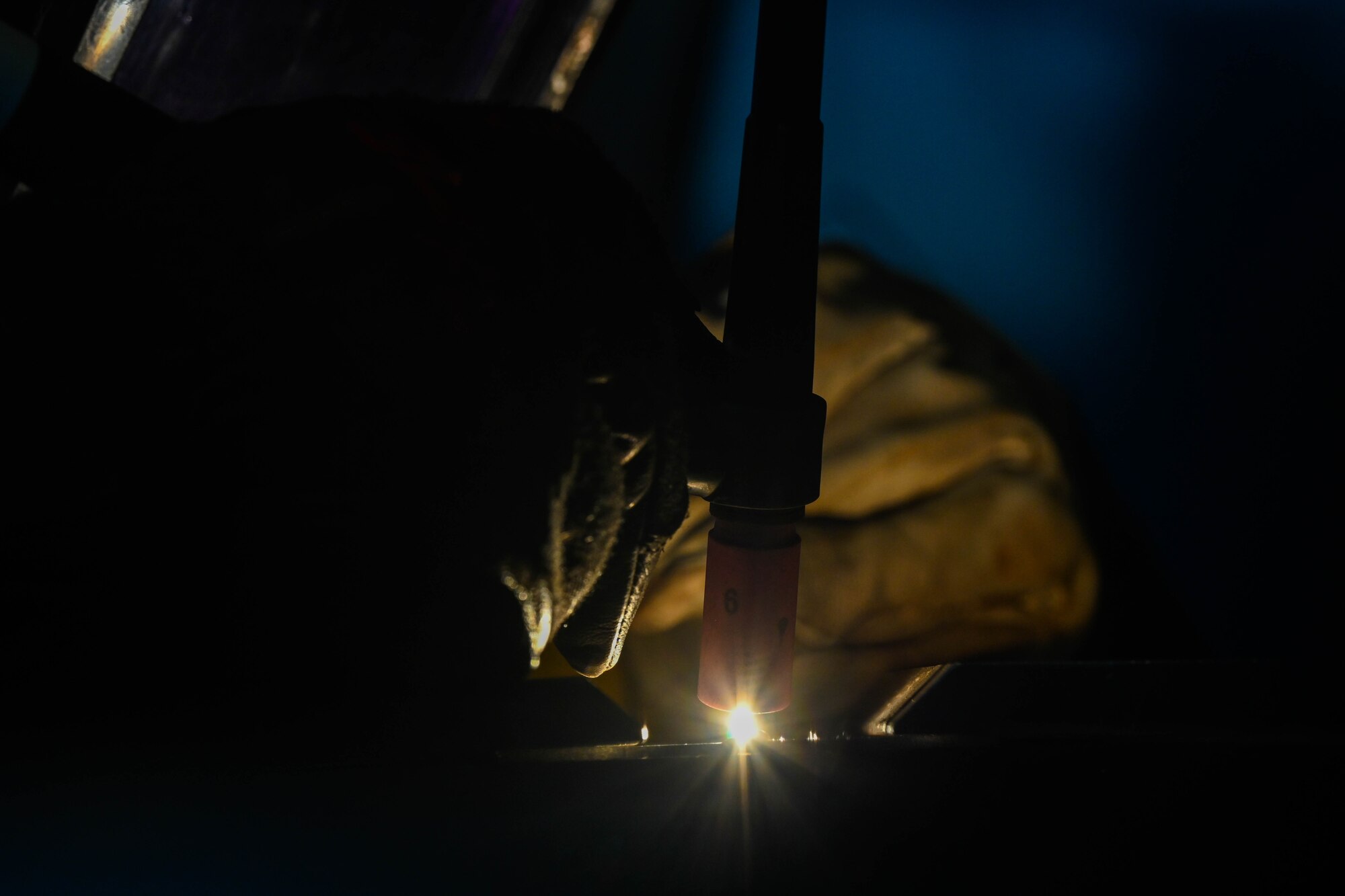 Airman uses metal fabrication equipment.