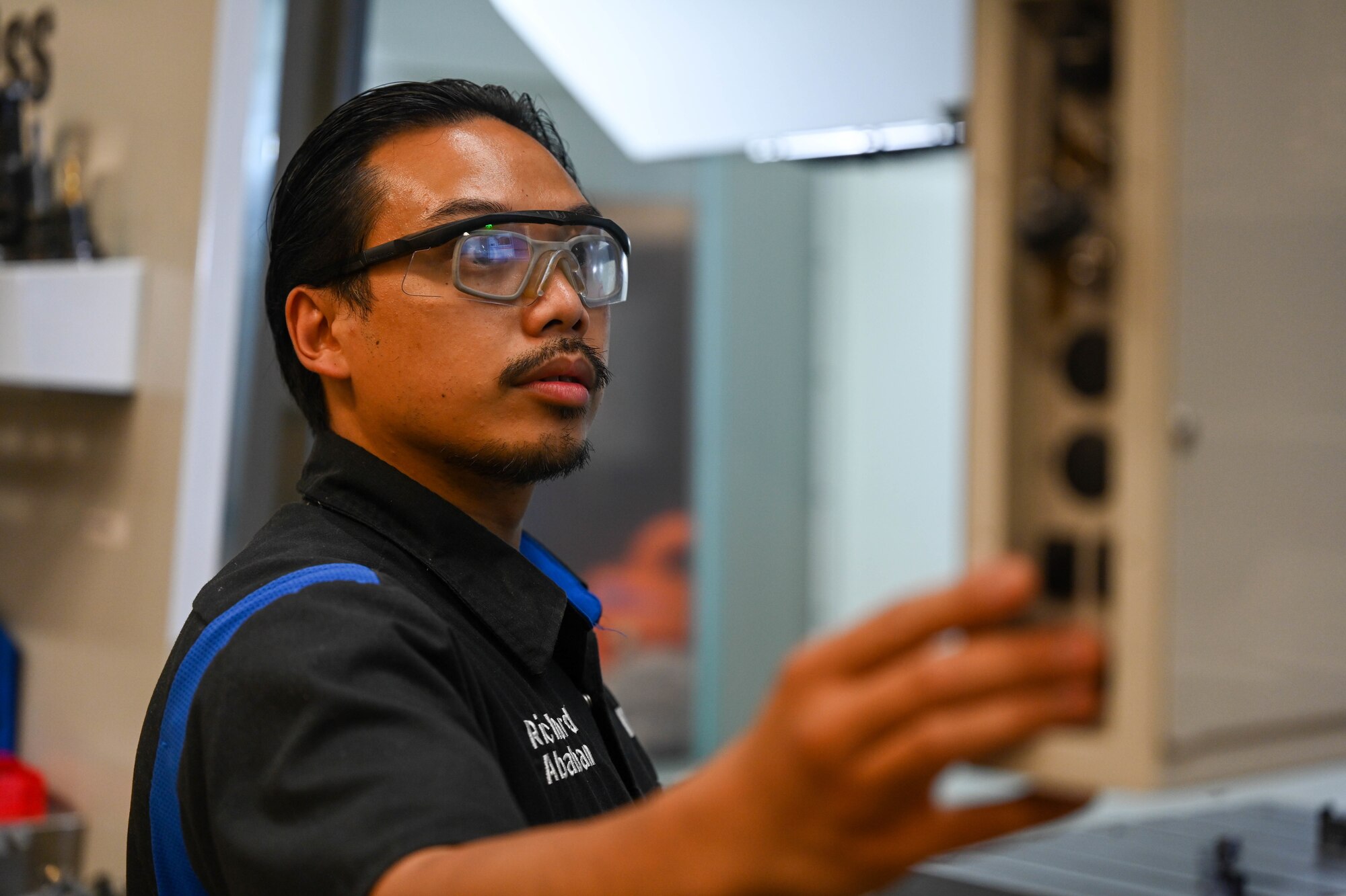Airman uses fabrication equipment.