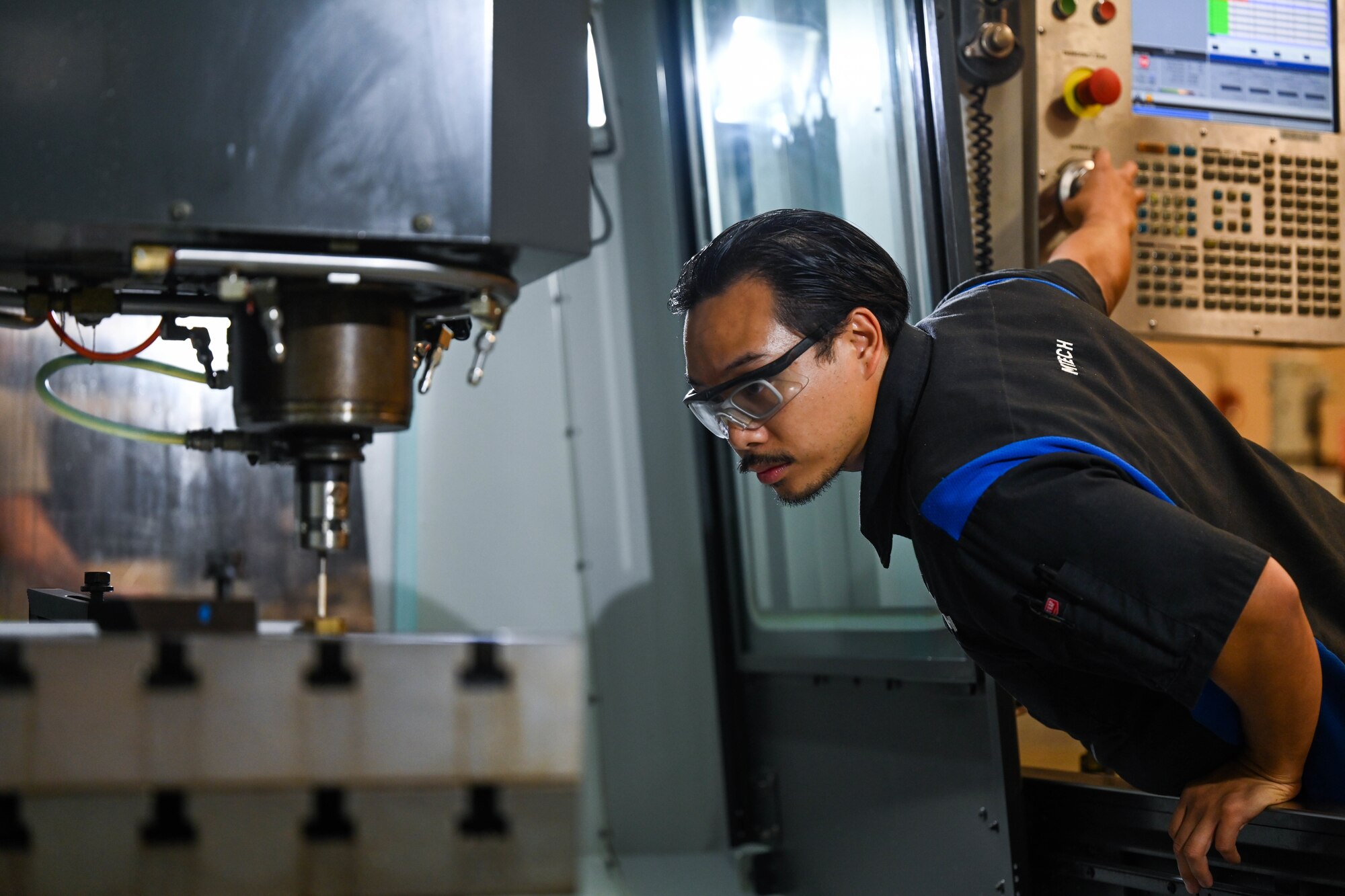 Airman uses metal fabrication equipment.