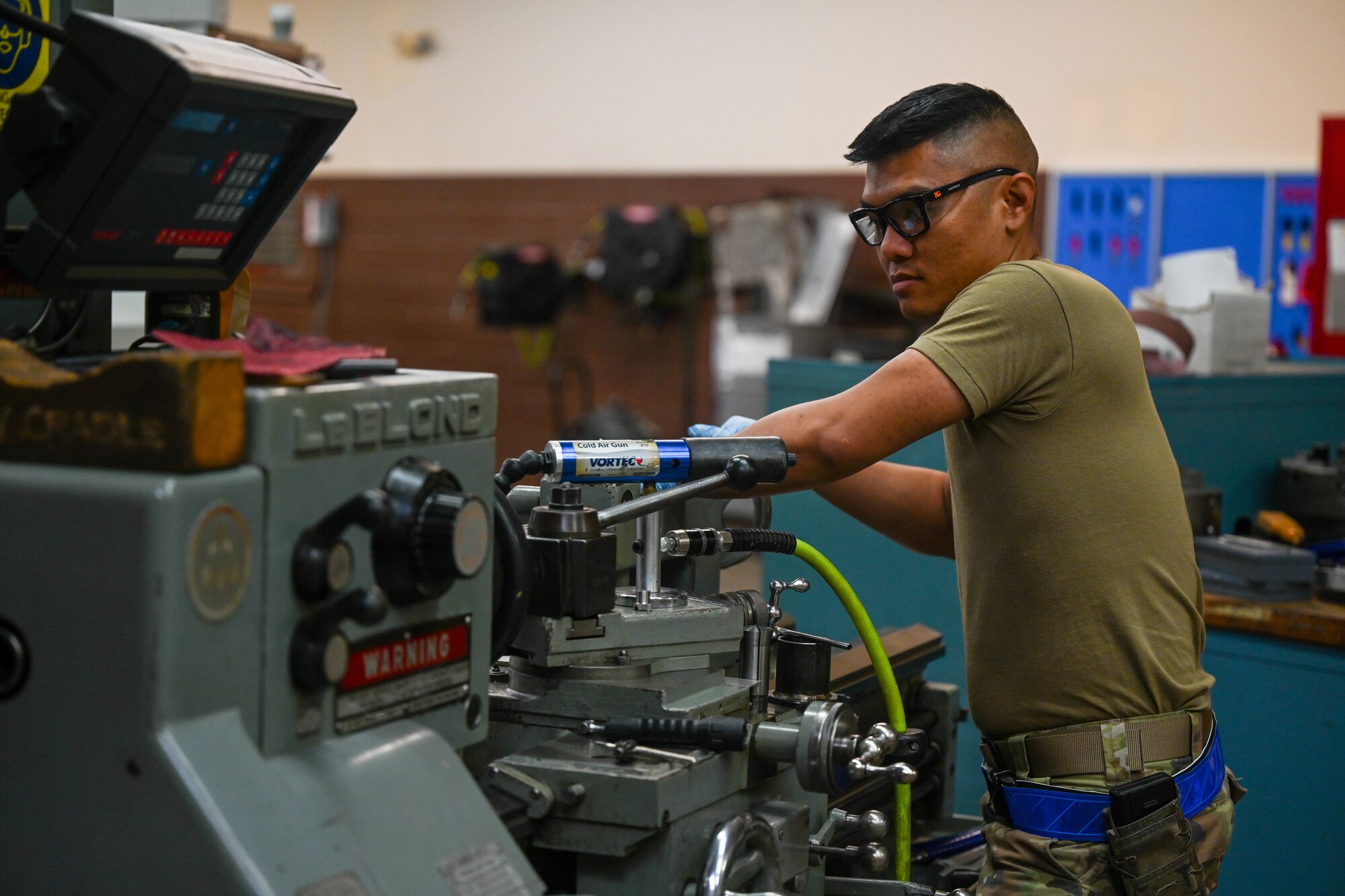 Airman uses metal fabrication equipment.