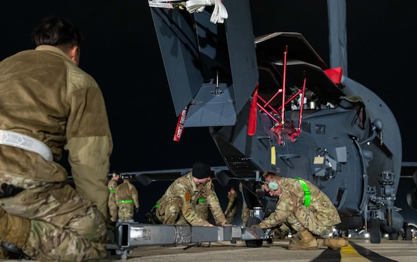 Airmen set up a tow for an HH-60W.