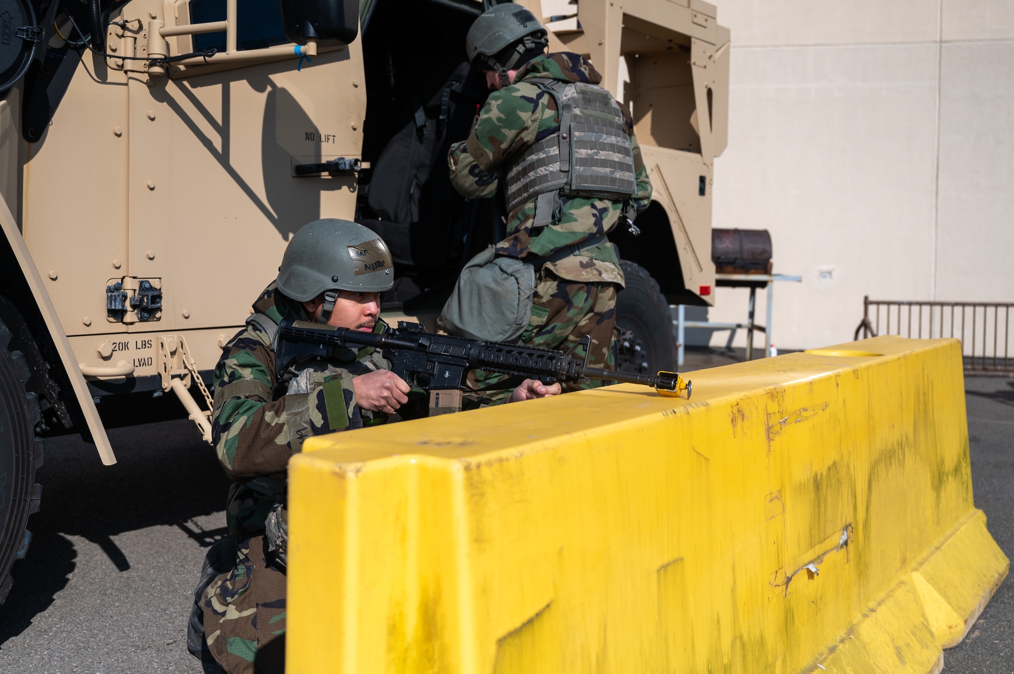 Senior Airman Casin Nestor, left, provides cover as Airman 1st Class Joshua Bauman gets into a defendable position during a ground attack exercise during Beverly Midnight 24-1.