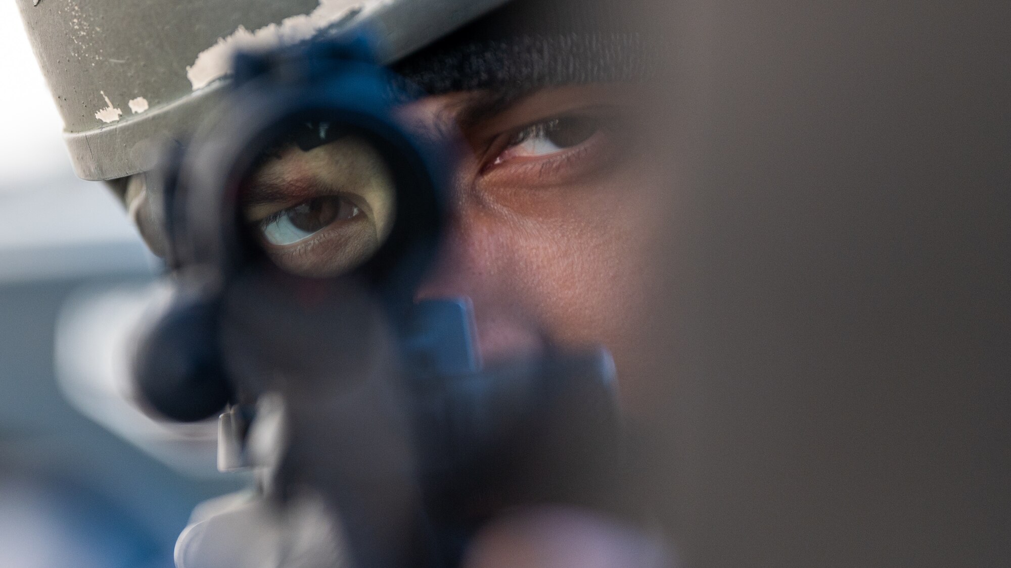 Staff Sgt. John Hauck aims down a scope while holding a defensive position during Beverly Midnight 24-1.