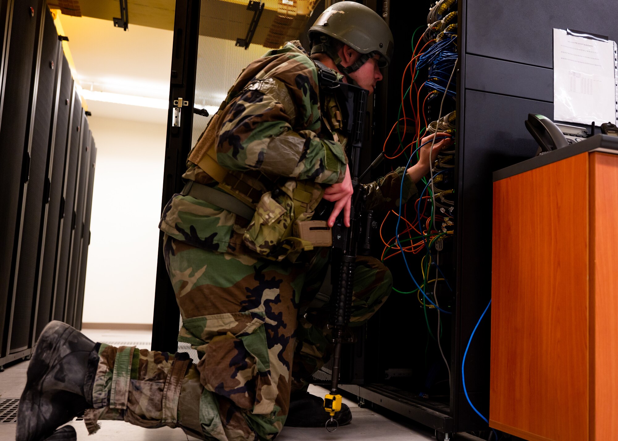Staff Sgt. Brandon Crawford works on servers during Beverly Midnight 24-1.