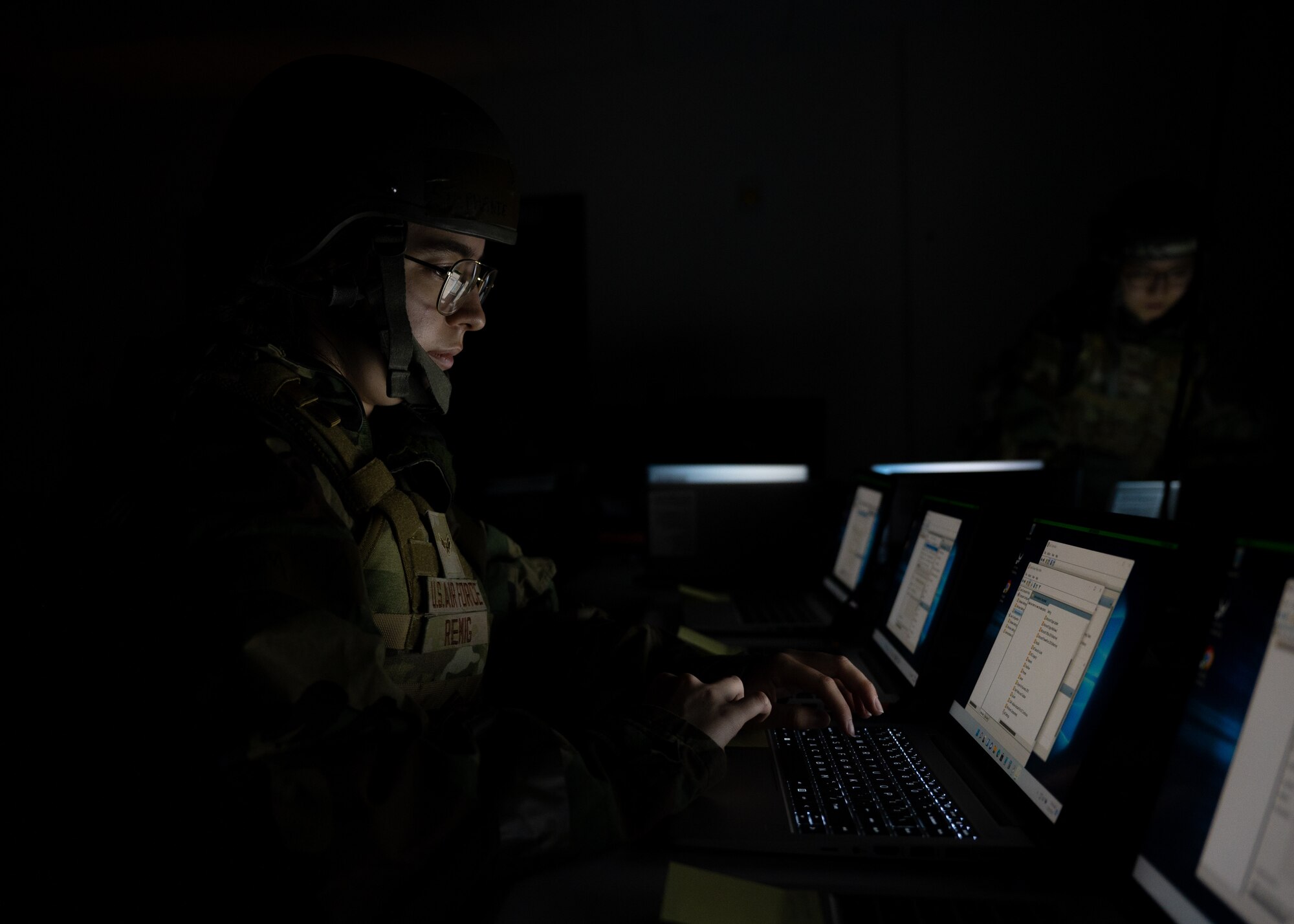 Airman 1st Class Stephanie Remig installs programs on new laptops during Beverly Midnight 24-1.