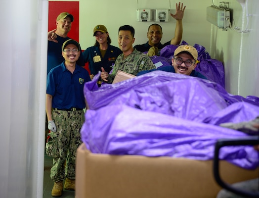 U.S. Navy Sailors participate in a working party to onload mail onto the hospital ship USNS Mercy (T-AH 19) during Pacific Partnership 2024-1 while anchored off Honiara, Solomon Islands, Dec. 1, 2023. Pacific Partnership, now in its 19th iteration, is the largest multinational humanitarian assistance and disaster relief preparedness mission conducted in the Indo-Pacific and works to enhance regional interoperability and disaster response capabilities, increase security stability in the region, and foster new and enduring friendships. (U.S. Navy photo by Mass Communication Specialist 2nd Class Celia Martin)