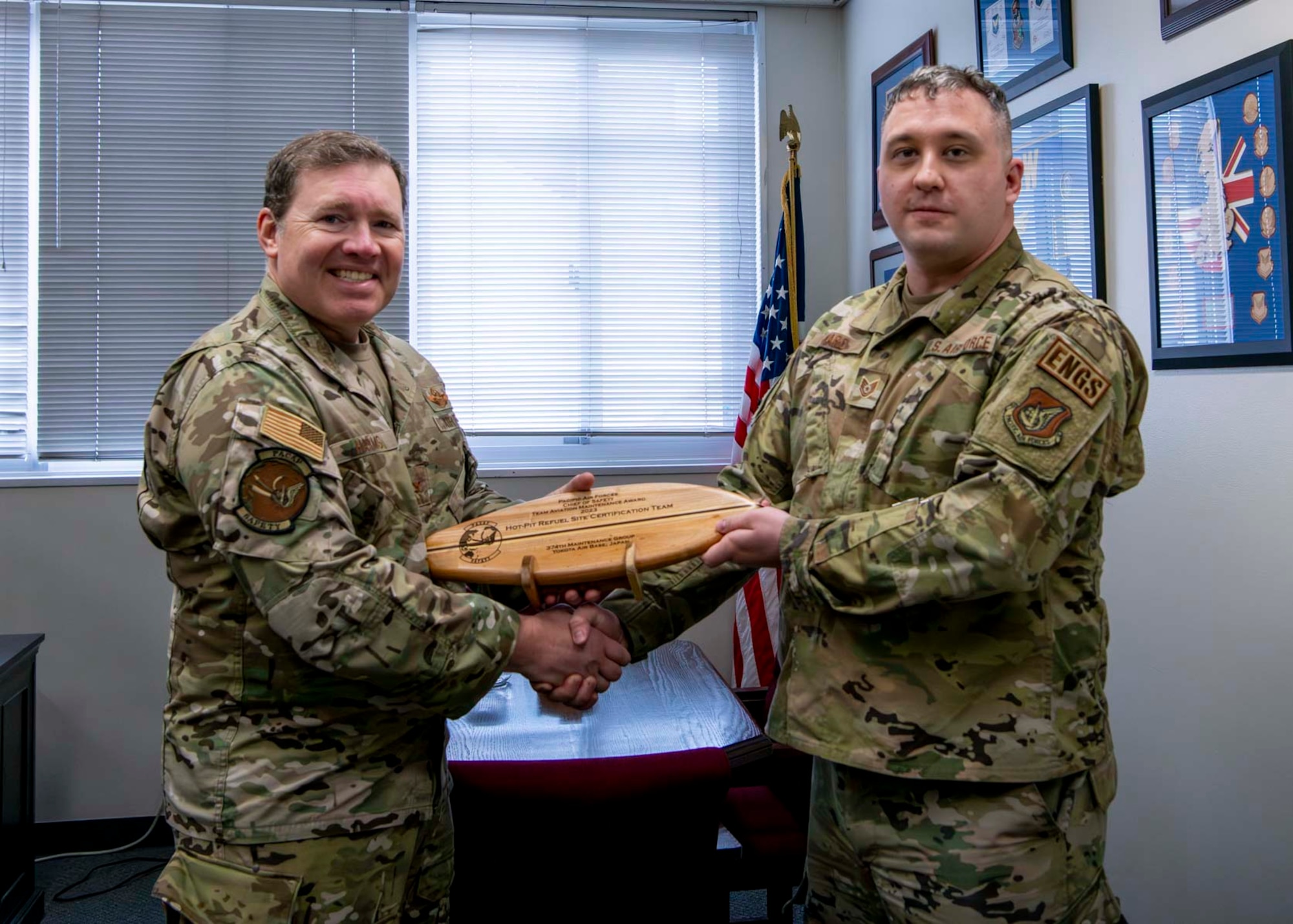 A military man receives an award from another military man.