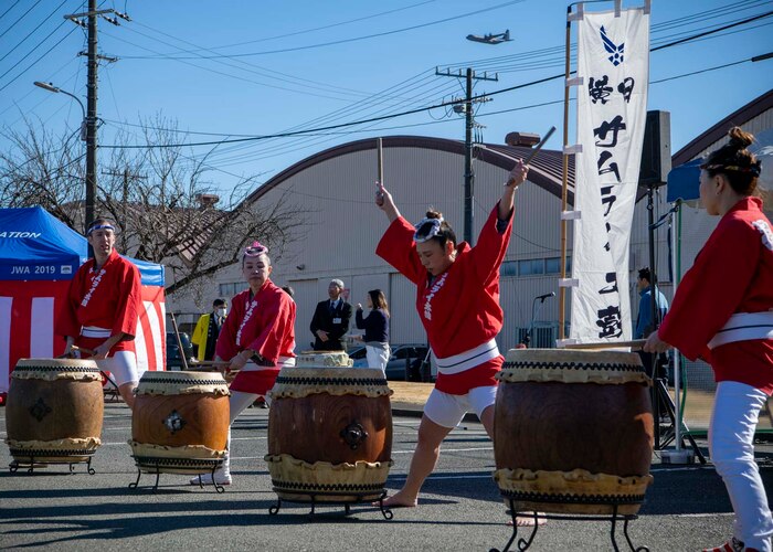 Performers play the drums.