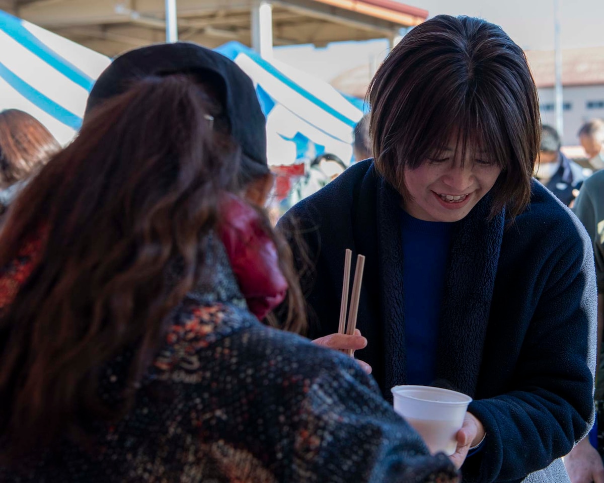 People eat food with chopsticks.