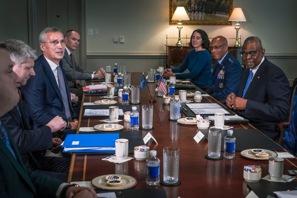 A group of people sit at a conference table.