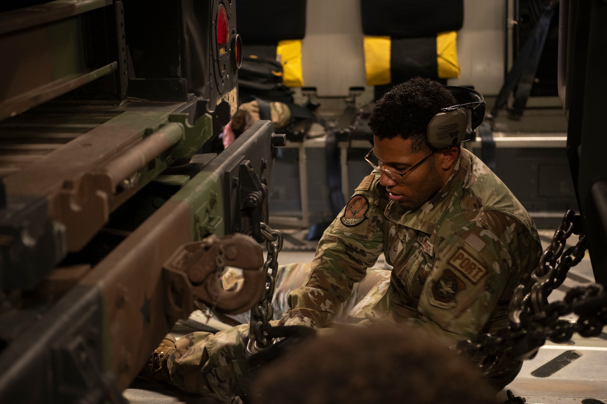 A photo of an Airman securing cargo.