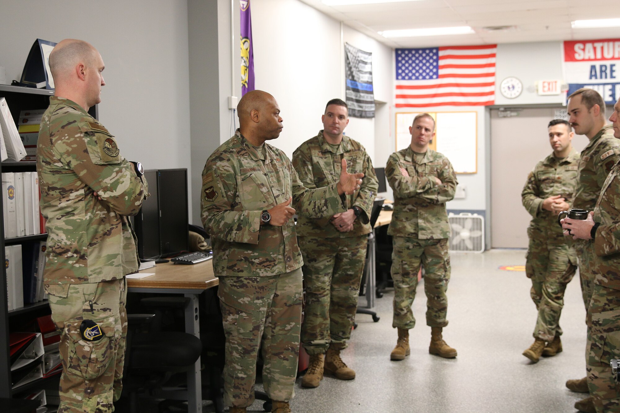 Chief Master Sgt. Travon W. Dennis, Fourth Air Force Command Chief, March Air Reserve Base, California, visits with Reserve Citizen Airmen from the 445th Security Forces Squadron during his visit to the 445th Airlift Wing Jan. 7, 2024.  While visiting security forces, he was briefed on the security forces weapons simulator trainer and other training events conducted. Chief Dennis visited the 445th Airlift Wing Jan. 6-7, 2024, and met Airmen from various squadrons and members assigned to the 445th Development and Training Flight. He toured the 445th Aeromedical Staging Squadron simulation lab and participated in an aircrew flight equipment demonstration. He also met with the 445th's Chief’s Group, Rising Six and First Sergeant Council. (U.S. Air Force photo/Tech. Sgt. Joel McCullough)