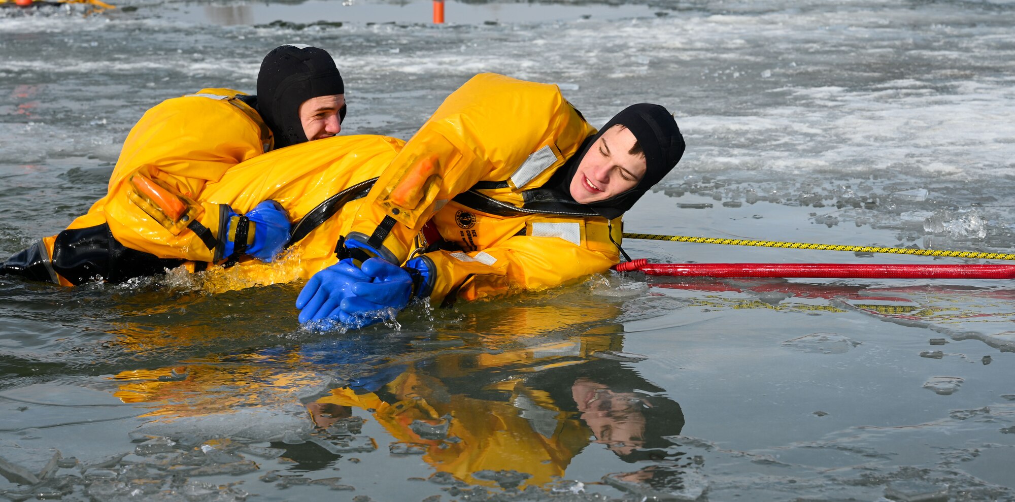 Firefighters participate in ice rescue training.
