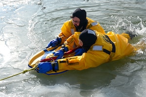 Airman in the Warren FD get pulled out of the ice during training.