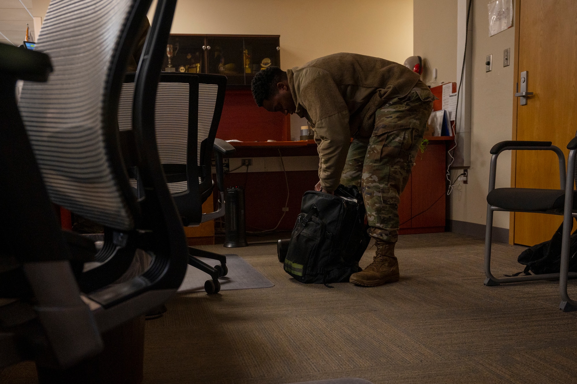 U.S. Air Force Staff Sgt. Jabari Freeman, 51st Operations Support Squadron weather technician, packs a bag to relocate to an alternate duty location during Beverly Midnight 24-1 at Osan Air Base, Republic of Korea, Jan. 29, 2024. BM24-1 is a routine training event that tests the military capabilities across the peninsula, allowing combined and joint training at both the operational and tactical levels. As the most forward deployed permanently based wing in the Air Force, the 51st Fighter Wing is charged with providing mission-ready Airmen to execute combat operations and receive follow-on forces. (U.S. Air Force photo by Senior Airman Kaitlin Castillo)