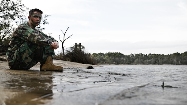 Lt. Jacob Westerberg, research psychologist for the Robert E. Mitchell Center (REMC) RPOW studies, sits by a water source and recounts the the mental rigors undergone by repatriated prisoners of war and his own mental challenges while providing his professional take on psychological experiences faced by those having to endure real-life survival scenarios like those taught in the survive evade resist and escape (SERE) training. Photos were captured onboard Naval Air Station Pensacola, Jan. 11. The Robert E. Mitchell Center houses the POW research studies program for all branches the armed forces and has been an active program for 50 years as of 2023. (U.S. Navy photo by Mass Communication Specialist 1st Class Russell Lindsey SW/AW)