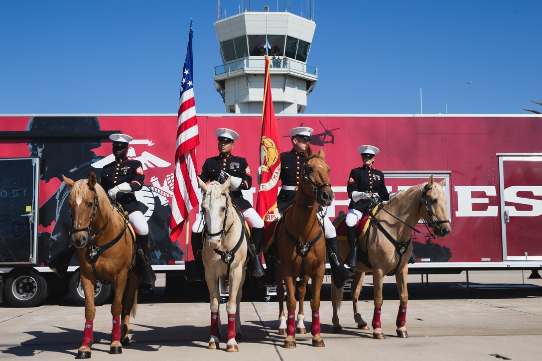 Members of the U.S. Marine Corps Mounted Color Guard greet spectators before the 2023 Marine Corps Air Station Miramar Airshow in San Diego, Sept. 23, 2023. America's Airshow 2023 is a unique and incredible opportunity to witness Marine and joint aviation capabilities, civilian performers, and the world-famous Blue Angels; to interact first-hand with Marines, other service members, and first responders; and to see first-hand the innovative spirit of the Marine Corps through emerging technologies and forward-thinking. (U.S. Marine Corps photo by Staff Sgt. Dana Beesley)