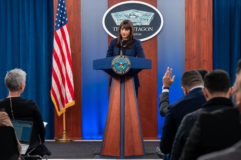 Deputy Pentagon Press Secretary Sabrina Singh stands behind a podium looking at reporters.