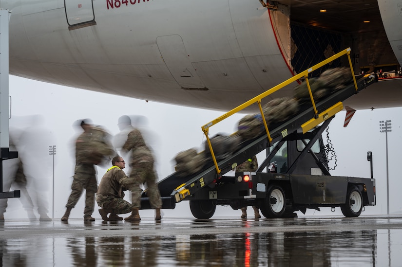 U.S. Army Soldiers assigned to the 44th Infantry Brigade Combat Team, New Jersey Army National Guard, and U.S. Air Force Airmen from the 305th Air Mobility Wing load their bags at Joint Base McGuire-Dix-Lakehurst, N.J., Jan. 25, 2024. More than 1,500 NJARNG Soldiers are deploying to support U.S. Central Command’s Combined Joint Task Force-Operation Inherent Resolve. This is the largest deployment of NJARNG Soldiers since 2008. (U.S. Air Force photo by Senior Airman Sergio Avalos)
