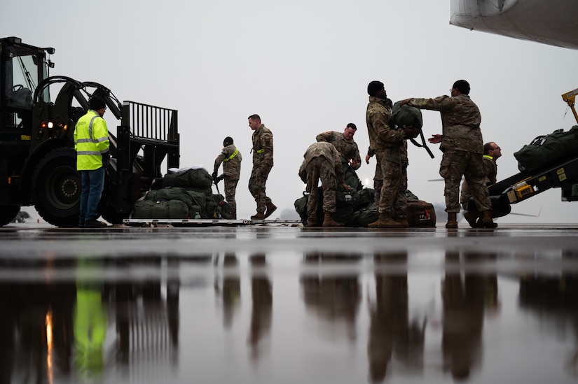 U.S. Army Soldiers with the New Jersey Army National Guard and U.S. Air Force Airmen from the 305th Air Mobility Wing load their bags at Joint Base McGuire-Dix-Lakehurst, N.J., Jan. 25, 2024. More than 1,500 NJARNG Soldiers are deploying to support U.S. Central Command’s Combined Joint Task Force-Operation Inherent Resolve. This is the largest deployment of NJARNG Soldiers since 2008. (U.S. Air Force photo by Senior Airman Sergio Avalos)