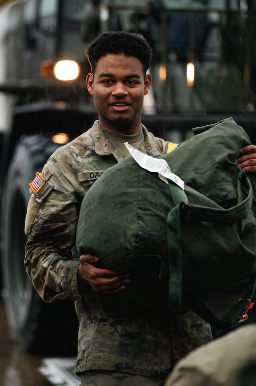 A U.S. Army Soldier loads deployment bags onto aircraft at Joint Base McGuire-Dix-Lakehurst, N.J., Jan. 25, 2024. More than 1,500 New Jersey Army National Guard Soldiers are deploying to support U.S. Central Command’s Combined Joint Task Force-Operation Inherent Resolve. This is the largest deployment of NJARNG Soldiers since 2008. (U.S. Air Force photo by Senior Airman Sergio Avalos)