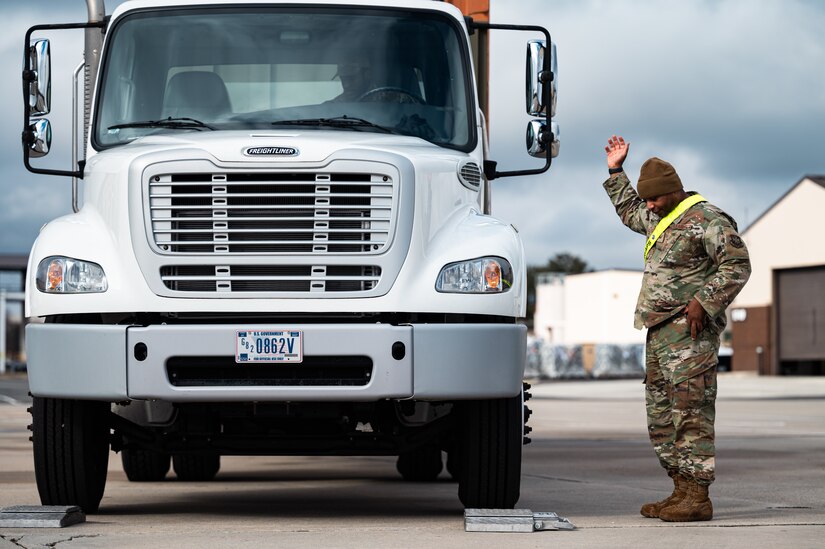 A U.S. Air Force Airman from the 305th Aerial Port Squadron directs a truck full of deployment bags at Joint Base McGuire-Dix-Lakehurst, N.J., Jan. 27, 2024. More than 1,500 New Jersey Army National Guard Soldiers are deploying to support U.S. Central Command’s Combined Joint Task Force-Operation Inherent Resolve. This is the largest deployment of NJARNG Soldiers since 2008. (U.S. Air Force photo by Senior Airman Sergio Avalos)
