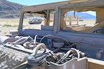 Vehicles to be used as targets lined up in the desert.