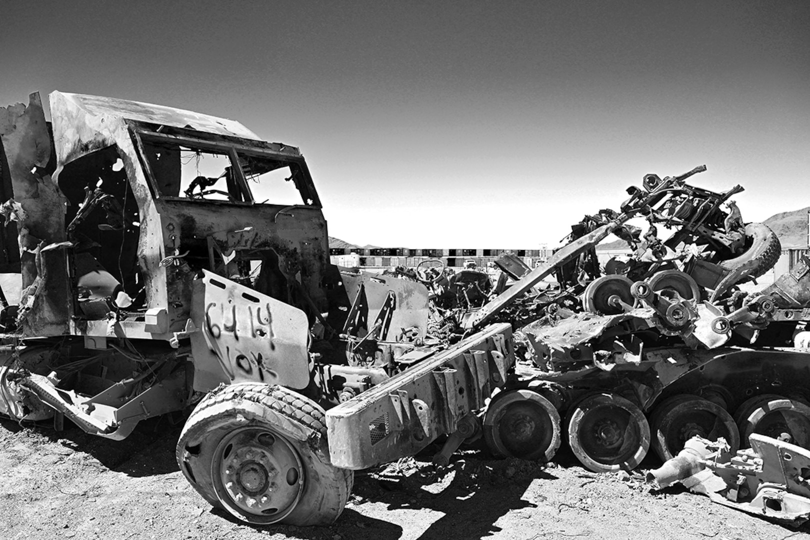 Mangled vehicles and shipping containers.
